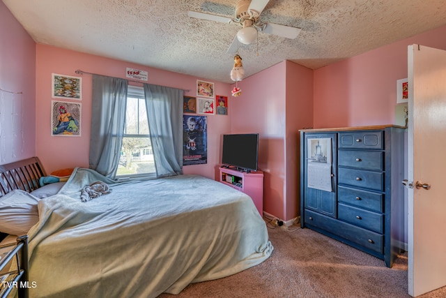 carpeted bedroom featuring ceiling fan and a textured ceiling