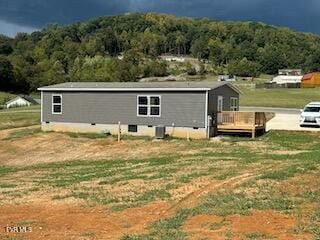 exterior space with a wooden deck and a yard