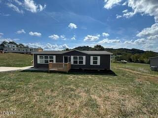 view of front of house with a front lawn and a wooden deck