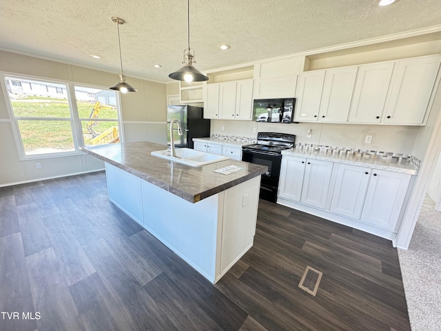 kitchen featuring black appliances, a textured ceiling, hanging light fixtures, an island with sink, and white cabinets