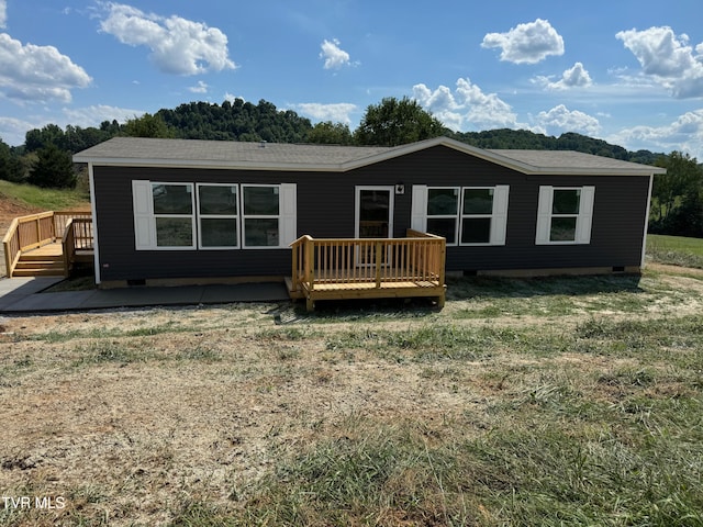 back of house featuring a wooden deck