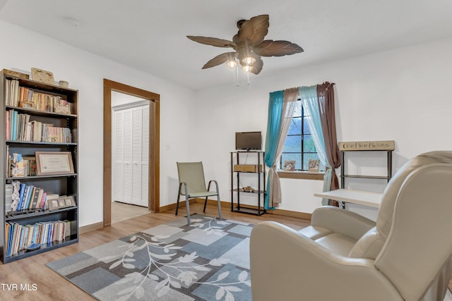 sitting room with ceiling fan and light hardwood / wood-style flooring