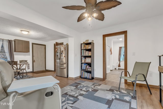 home office featuring ceiling fan and light hardwood / wood-style flooring