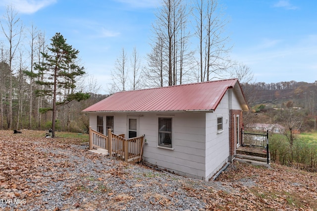 view of side of home featuring a wooden deck