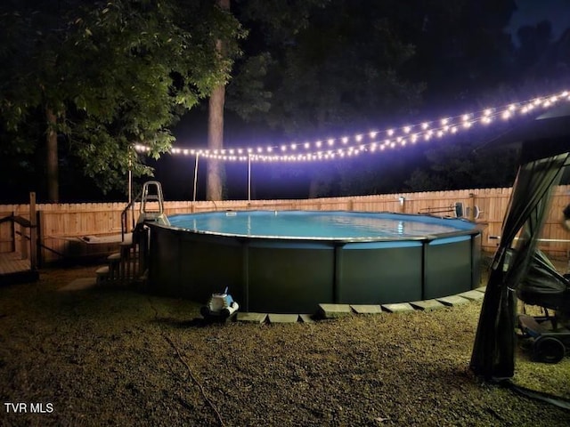 view of pool at night