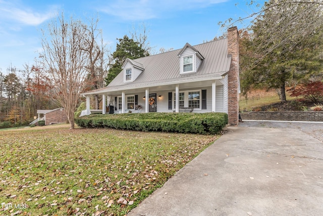 cape cod house with a porch and a front lawn