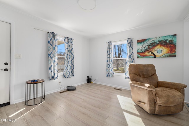 sitting room featuring light hardwood / wood-style flooring