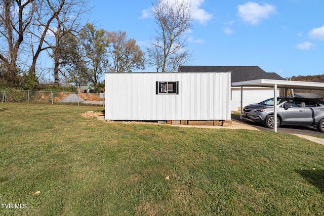 view of outbuilding featuring a lawn and a carport