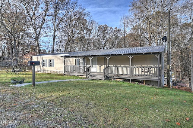 view of front of house with a front yard and a wooden deck