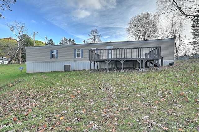 rear view of property with central AC, a lawn, and a wooden deck