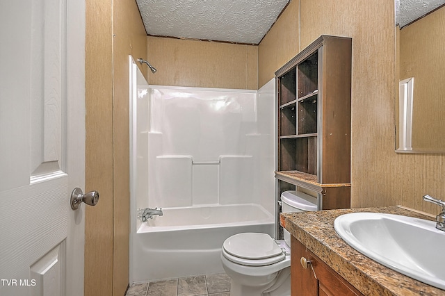 full bathroom with shower / bathtub combination, vanity, a textured ceiling, tile patterned flooring, and toilet