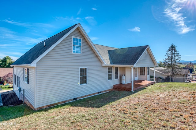 rear view of property with a yard