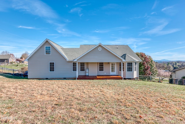 view of front of home with a wooden deck and a front lawn