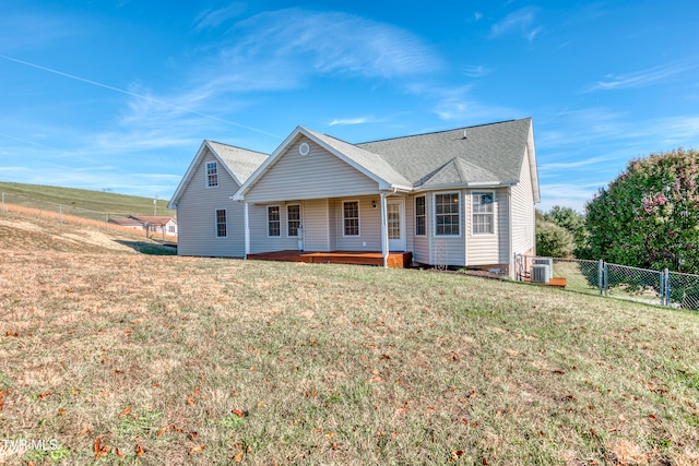 view of front of property featuring central AC and a front yard