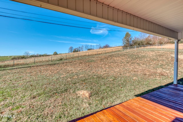 view of yard featuring a rural view and a deck