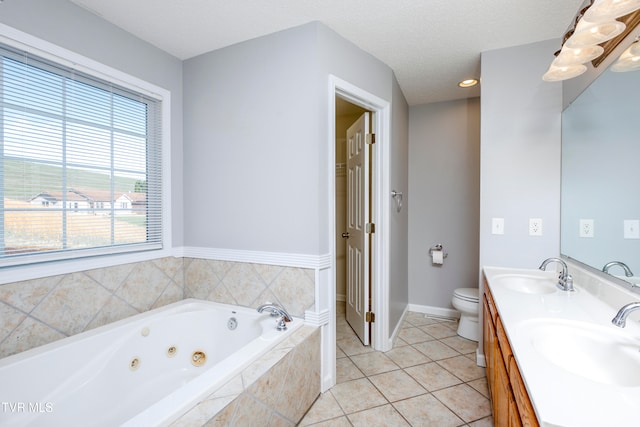 bathroom with vanity, toilet, tile patterned floors, and a textured ceiling