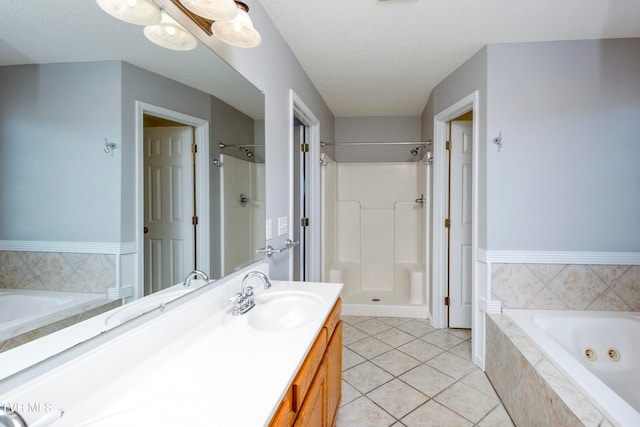 bathroom with vanity, plus walk in shower, tile patterned flooring, and a textured ceiling