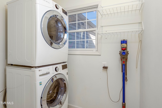 clothes washing area featuring stacked washer / dryer