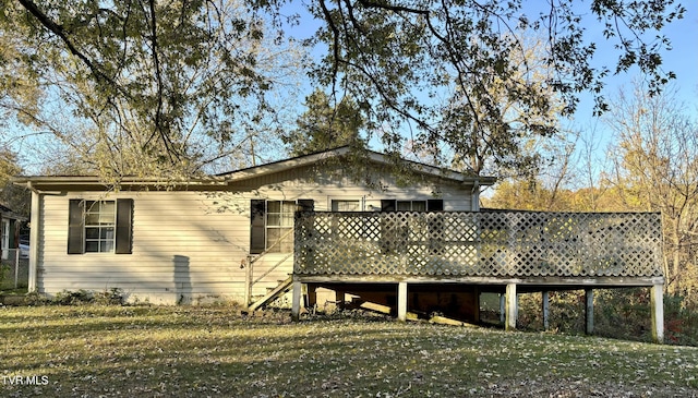 view of home's exterior featuring a lawn and a deck