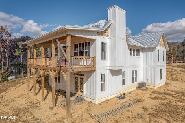 back of house featuring cooling unit and a wooden deck