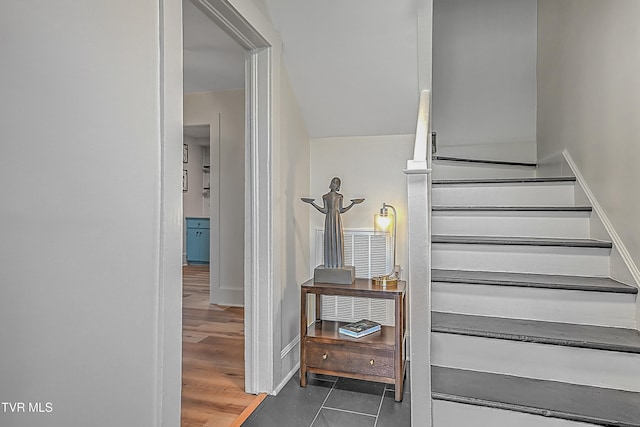 staircase featuring hardwood / wood-style flooring