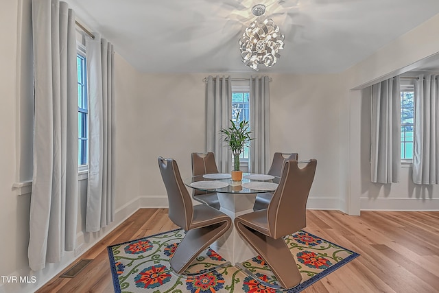 dining room featuring a chandelier and light hardwood / wood-style flooring