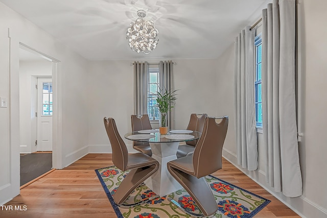 dining room featuring a chandelier and light hardwood / wood-style flooring