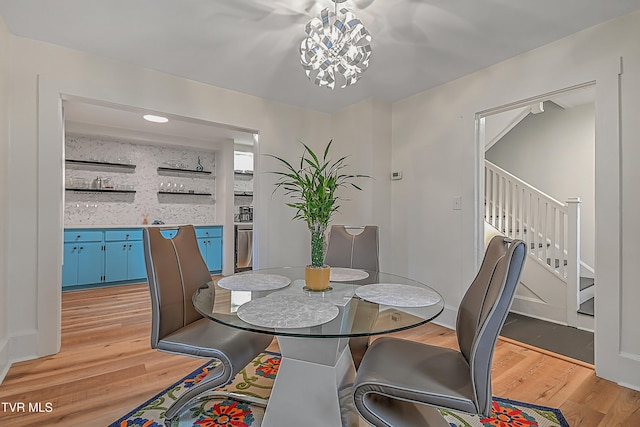 dining room featuring light hardwood / wood-style floors and a notable chandelier