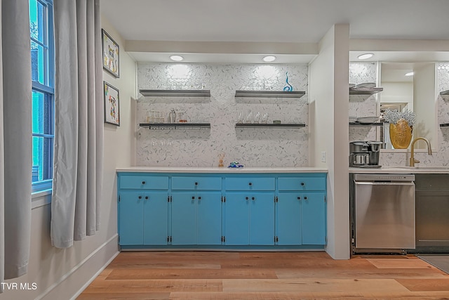 bar featuring dishwasher, decorative backsplash, light hardwood / wood-style flooring, and a healthy amount of sunlight