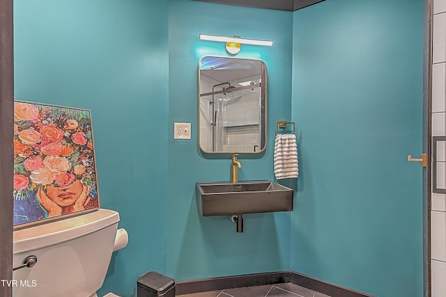 bathroom with tile patterned flooring, toilet, and sink