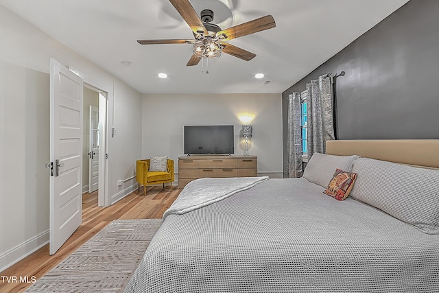 bedroom featuring ceiling fan and light hardwood / wood-style flooring