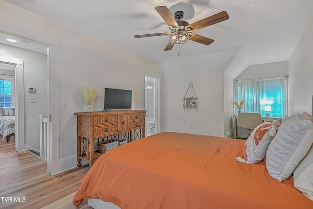 bedroom with ceiling fan, light hardwood / wood-style floors, and connected bathroom