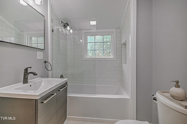 full bathroom featuring vanity, tiled shower / bath, vaulted ceiling, and toilet