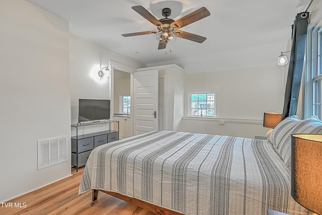 bedroom with ceiling fan and light hardwood / wood-style flooring