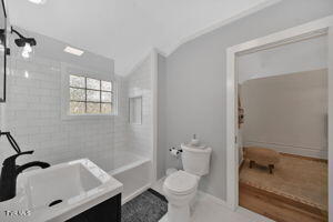 full bathroom with vanity, toilet, and tiled shower / bath