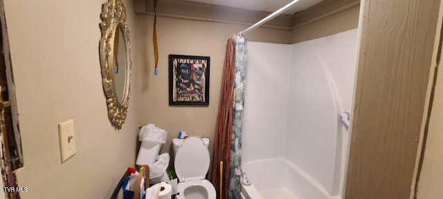 bathroom with toilet and shower / tub combo