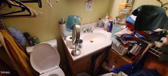 bathroom featuring toilet and vanity