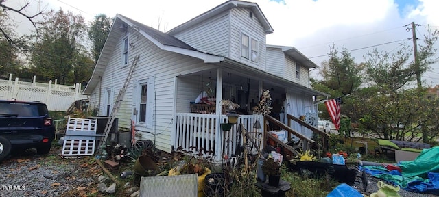 view of side of property with a porch