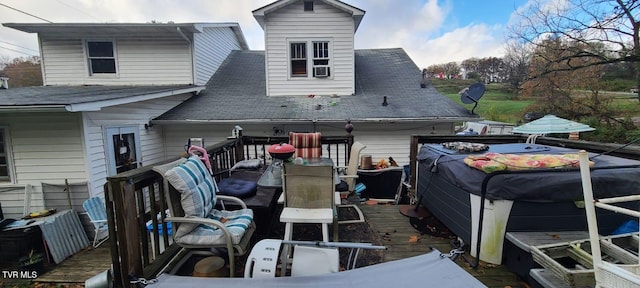 rear view of house featuring a deck