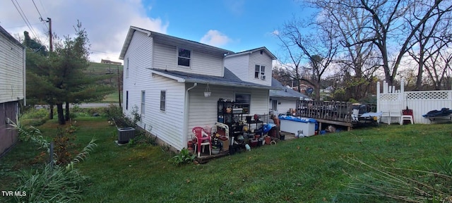 rear view of property with a yard and cooling unit