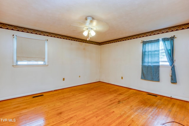 empty room featuring light wood-type flooring and ceiling fan