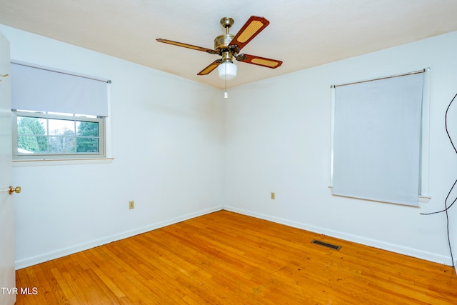 spare room with wood-type flooring and ceiling fan