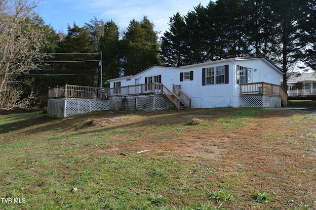 exterior space featuring a lawn and a deck