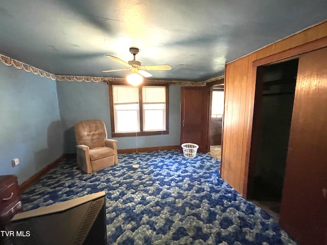 living area with carpet floors and ceiling fan