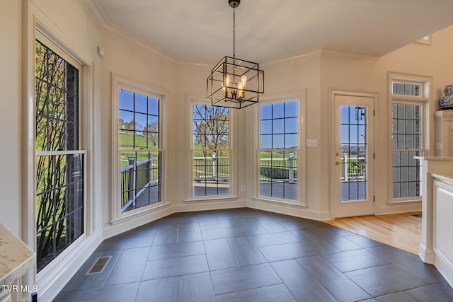 doorway with dark hardwood / wood-style flooring, a notable chandelier, and a healthy amount of sunlight