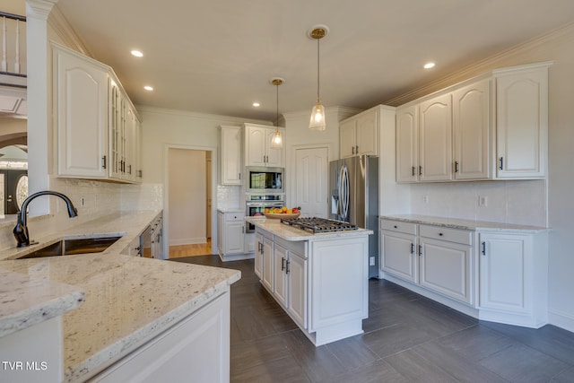 kitchen with light stone counters, sink, pendant lighting, and appliances with stainless steel finishes