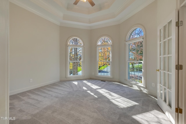 spare room featuring ornamental molding, light colored carpet, and ceiling fan