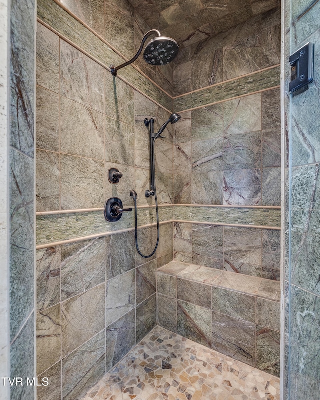 bathroom with a tile shower