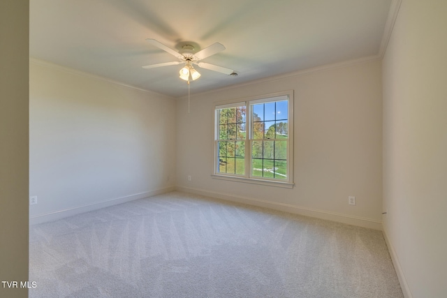 empty room featuring ceiling fan, light colored carpet, and ornamental molding