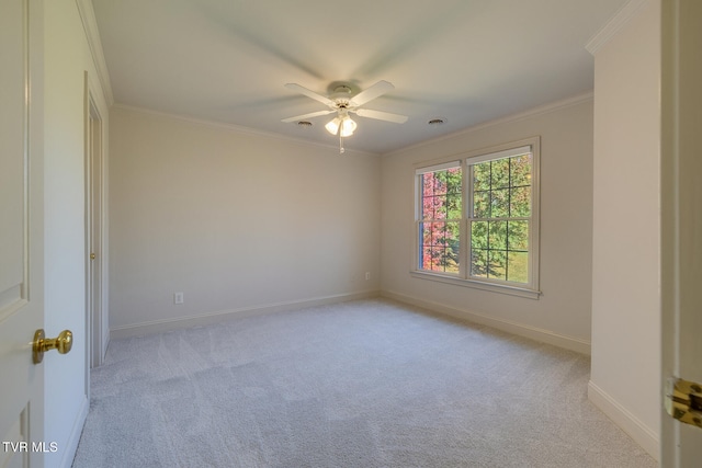 carpeted empty room featuring ceiling fan and ornamental molding